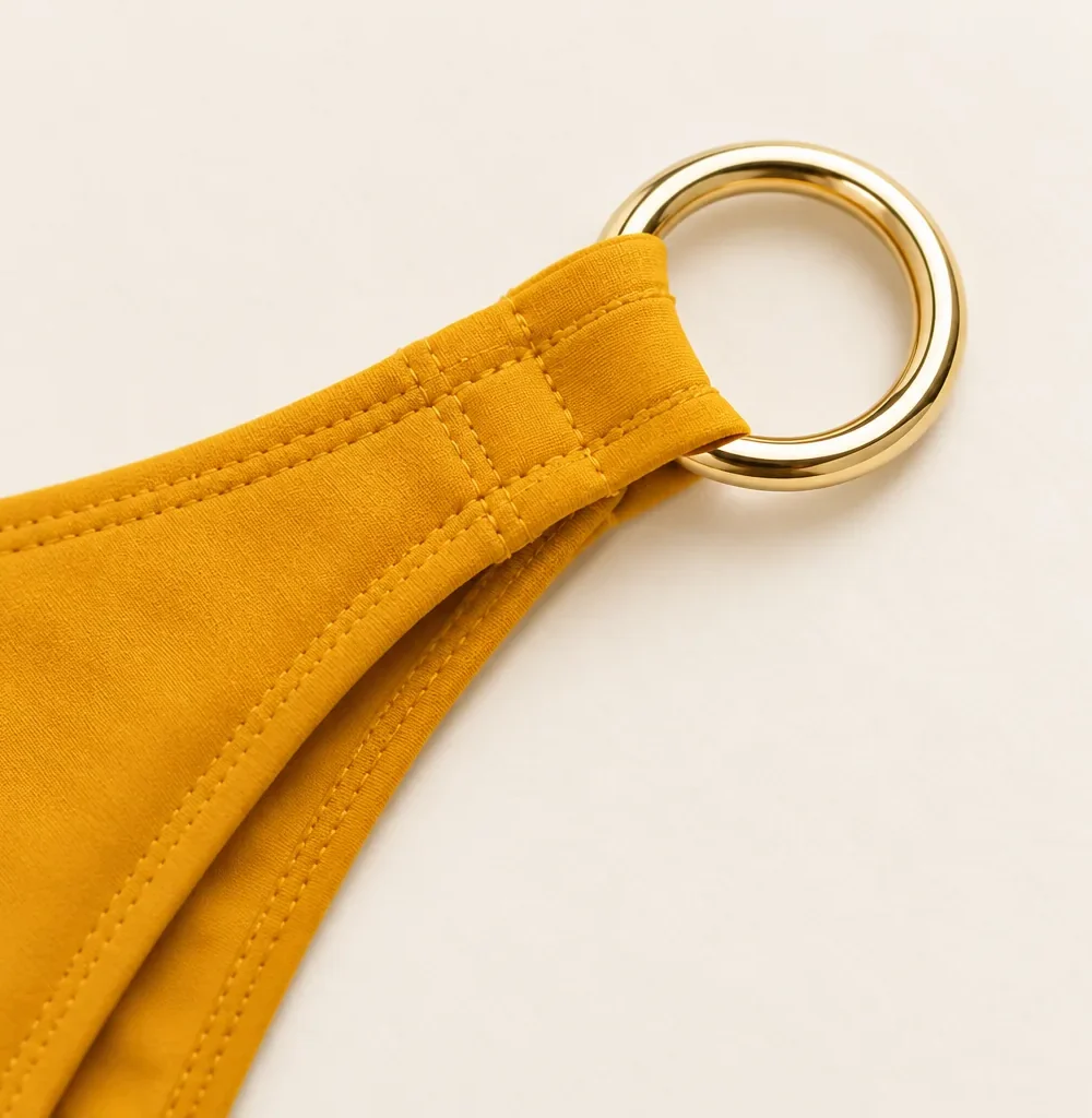 Apogee High-leg Bottom, close-up of the gold ring