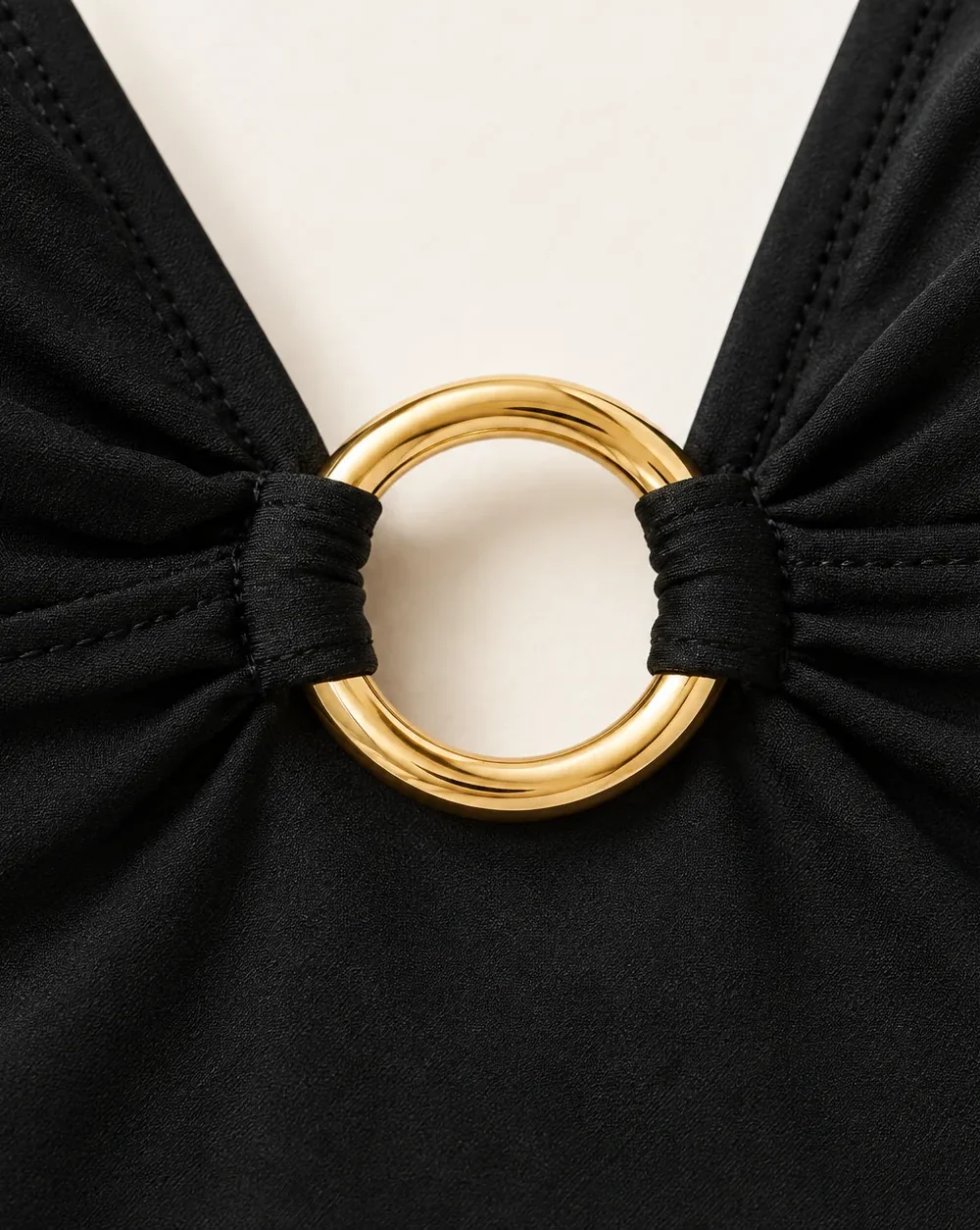 Eclipse Plunge One-piece, close-up of the gold ring