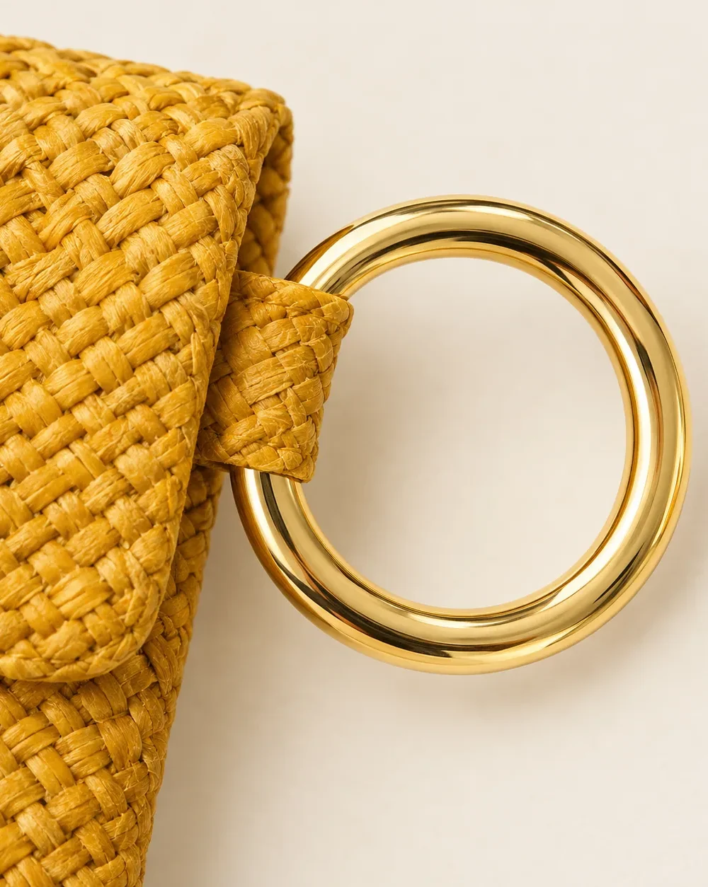 Ring-handle Beach Clutch, close-up of the gold ring