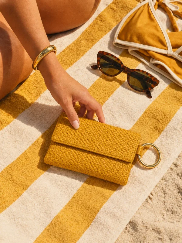 Ring-handle Beach Clutch, worn on the beach