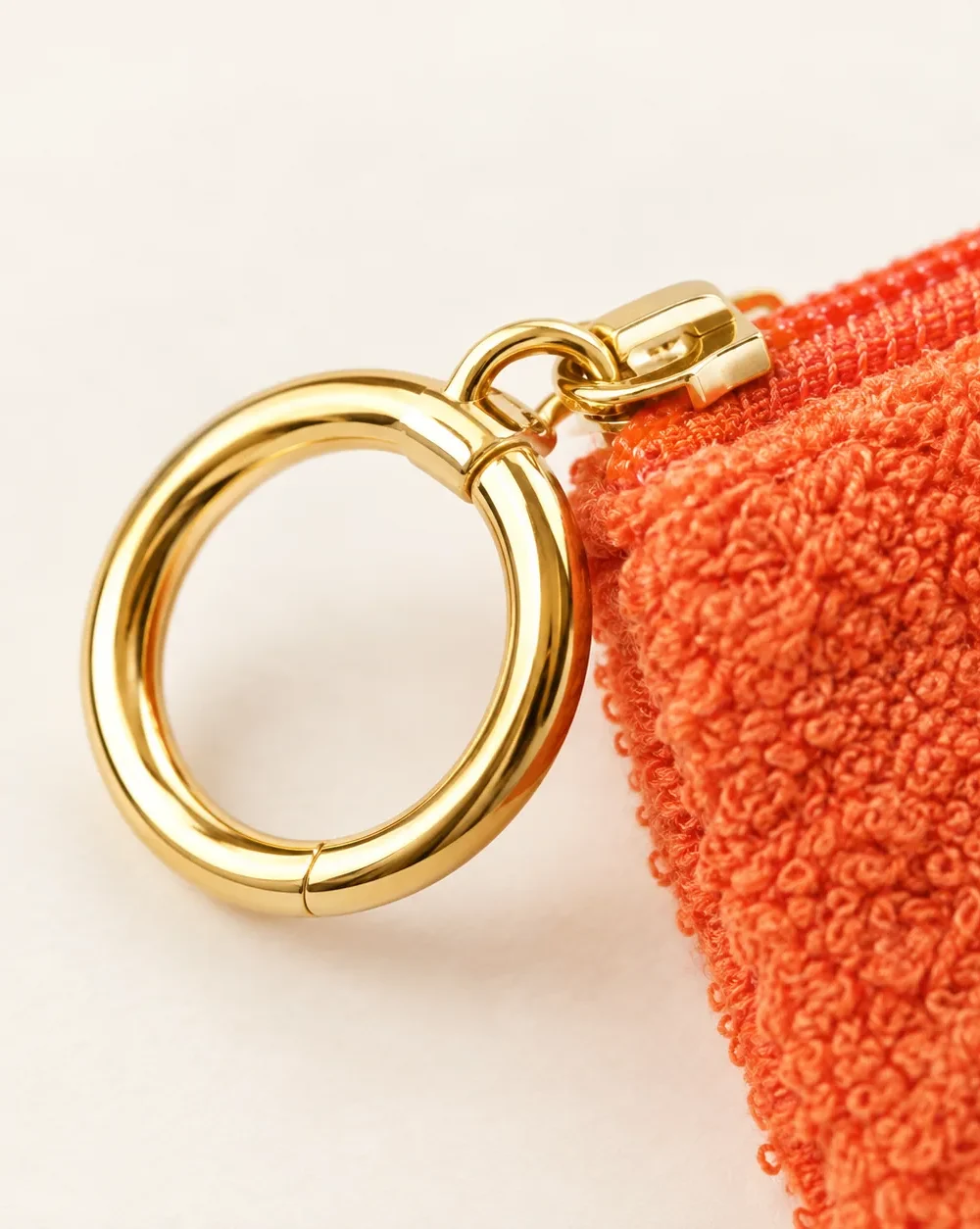 Ring-zip Terry Pouch, close-up of the gold ring